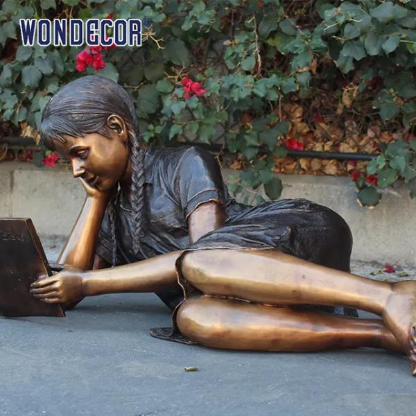 Customized garden decoration, life-size bronze statue of a girl lying on her side reading a book